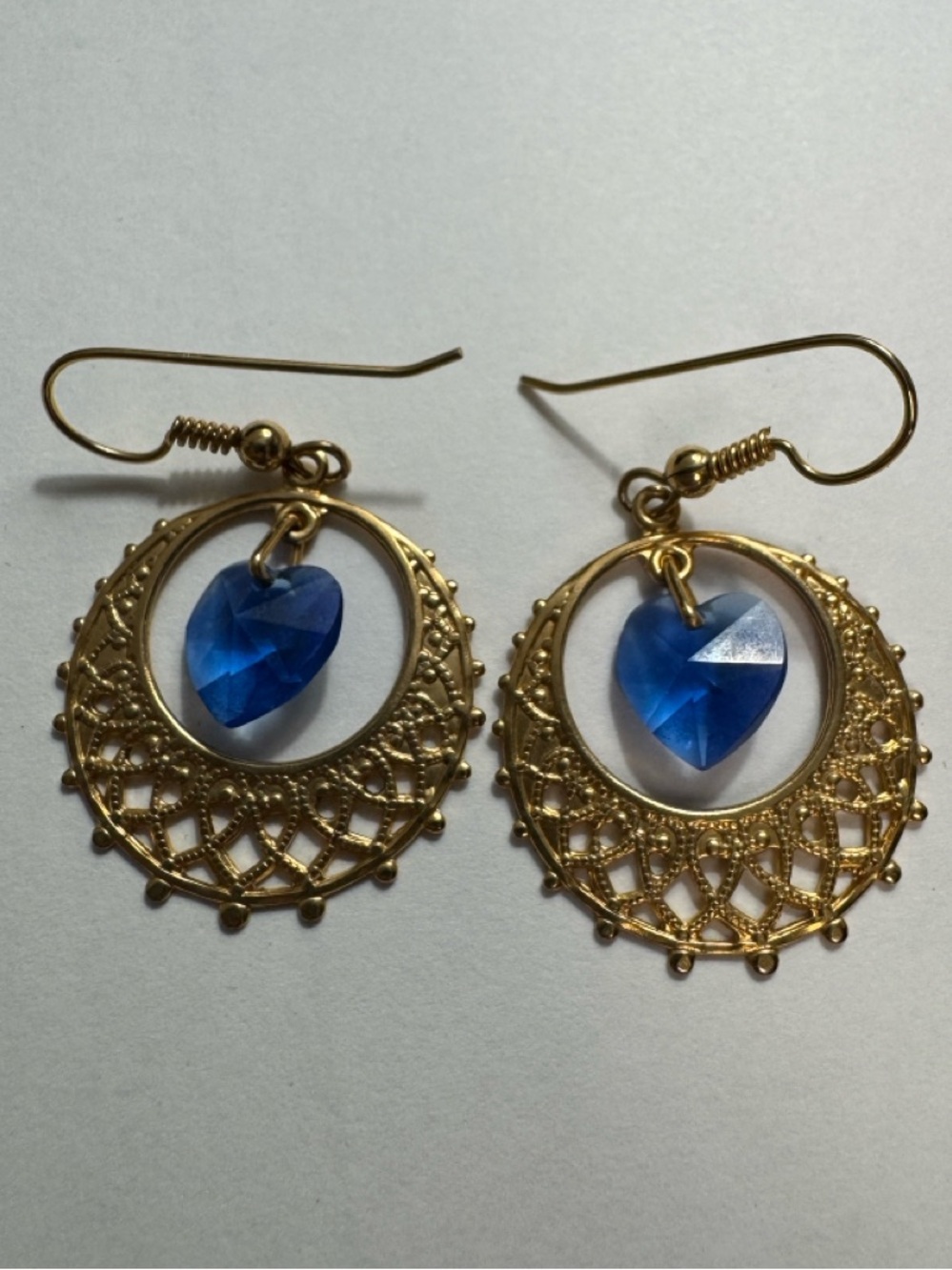 Gold-toned dangle earrings, filigree crescent, blue heart-shaped crystal drop.
